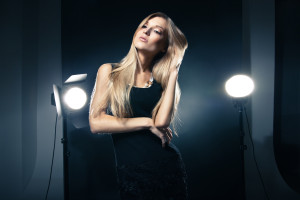 Beautiful woman posing at studio in light flashes